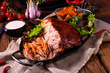 delicious pulled pork with baked potato quarters
