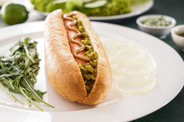 Tasty hot dog on plate, closeup