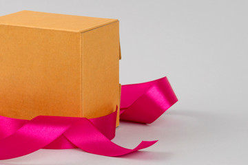 Cardboard box. Closed box on a white background. Gift boxes with pink ribbons. Birthday.