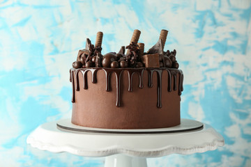 Tasty chocolate cake on color background