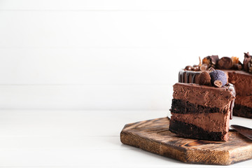 Tasty chocolate cake on white table