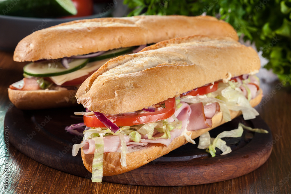 Sticker submarine sandwiches with ham, cheese and vegetables