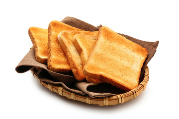 Wicker plate with slices of toasted bread on white background