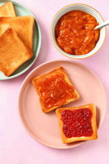 Tasty toasts with jam on color background