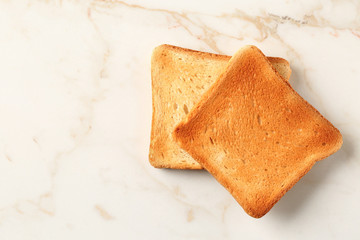 Tasty toasted bread on table
