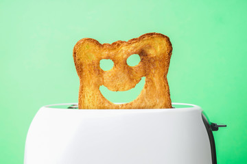 Funny slice of bread with toaster on color background
