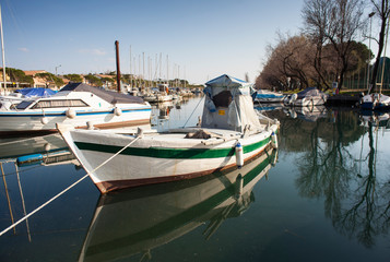 Fototapeta premium Boat docked in the Villaggio del Pescatore dock