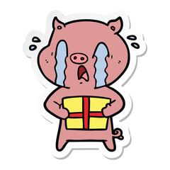 sticker of a crying pig cartoon delivering christmas present