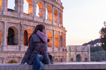 Rome/Italy 21 february 2019 :woman standing in front of colosseo in Rome he admires the greatness...