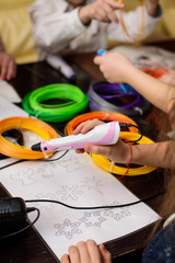 Children draw by 3d printing pen, working by melting ABS plastic 