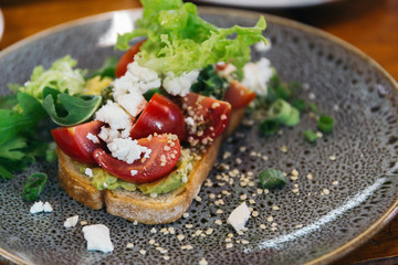 breakfast toast with vegetable, tomato, cheese, and  egg, avocado