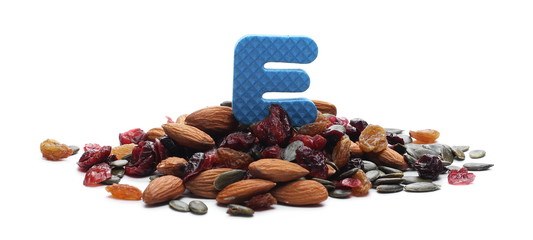 Power mix, dry blueberries, cherries, raisins, pumpkin seeds and raw almonds with letter, symbol E isolated on white background 