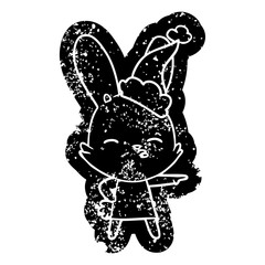 curious bunny cartoon distressed icon of a wearing santa hat