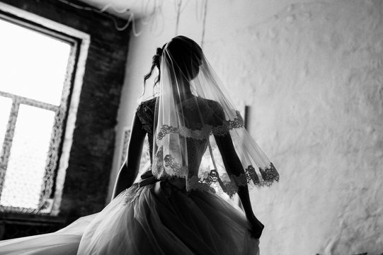 The bride is gathering in the morning. Stylish pink wedding dress. The bride is spinning in a dress. Black and white photo