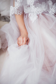 The bride is gathering in the morning. bride's hand. Stylish pink wedding dress.