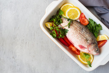 Raw carp fish with spices and vegetables for cooking. The view from the top. Copy space.