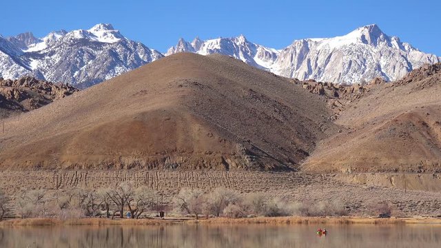 Kayakers enjoy a beautiful day at the base of Mt. Whitney and the Sierra Nevada mountains near Lone Pine, California.