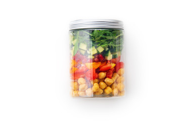 Healthy salad with chickpeas and arugula in a jar on white background. Take away easy lunch concept