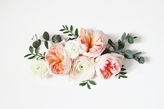 Floral Arrangement, Web Banner With Pink English Roses, Ranunculus, Carnation Flowers And Green Leaves On White Table Background. Flat Lay, Top View. Wedding Or Birthday Styled Stock Photography.