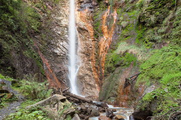 small waterfall among the forest in val di Funes