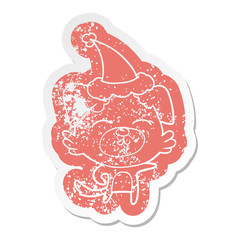 cartoon distressed sticker of a dog pointing wearing santa hat
