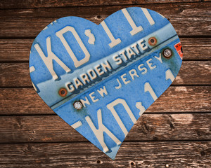 New Jersey state license plates in the shape of a heart on wood background