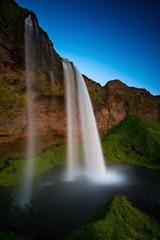 Fototapeta na wymiar The Seljalandsfoss waterfall in the last golden light. One of the most famous waterfalls in Iceland.