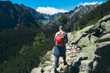 Fototapeta na wymiar Man tourist backpacks mountain hiking trail Healthy lifestyle