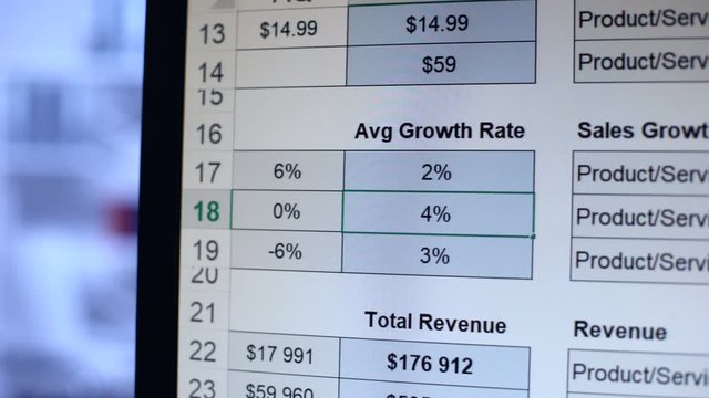 Person writing numbers to average growth rate table, calculation, bookkeeping