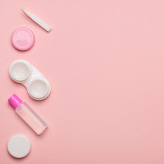 Accessories for contact lenses on a pink background. The view from the top.