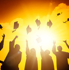 happy students throwing graduation caps in the Air