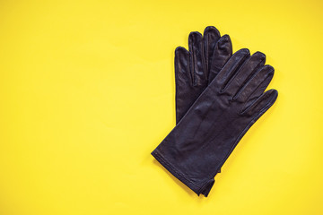 Sport concept. Black glove on yellow background