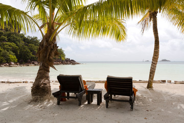 Tropical landscape view with deckchairs at Praslin island, Seychelles