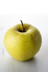 Wet yellow apple