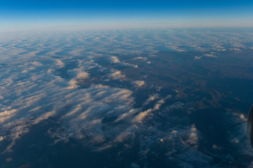 Naklejka na ściany i meble Flight scene plane window view clouds sunset