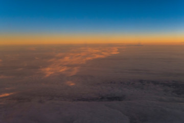 Fototapeta na wymiar Flight scene plane window view clouds sunset