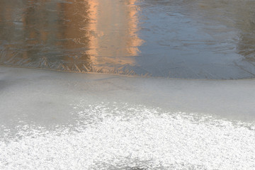 Fototapeta premium Snow and ice on a winter river. Winter texture and background