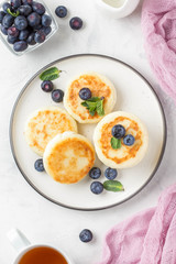 Cheesecakes from cottage cheese, delicious Breakfast, traditional Russian sweet pancakes. With blueberry, mint and sauce