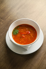 borscht soup in a bowl on table
