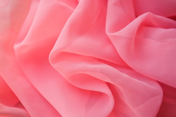 Pink georgette fabrics. The purple texture of the pleated fabric..