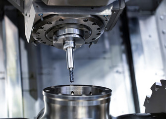 Cnc milling machine. Processing and cutting of parts from a piece of metal in the industrial area....