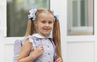 Back to school and happy time! Cute industrious child girl outdoors. Schoolgirl in school uniform.