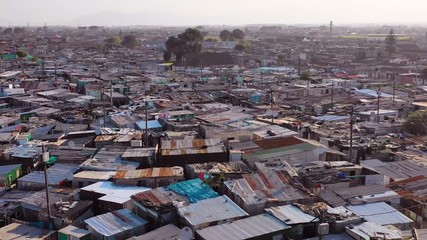 Aerial over ramshackle tin roofs of Gugulethu, one of the poverty stricken slums, ghetto, or townships of South Africa.
