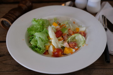Salmon and vegetable salad on old wooden