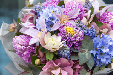 Beautiful elegant  pink purple blue bouquet of professional florist with different flowers close-up, macro. Floral background