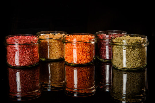 Row Of Small Glass Jars Filled With Different Colors Sea Salt