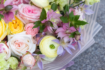 Beautiful elegant white yellow pink wedding bouquet of florist with roses and different flowers close up, macro. Floral background
