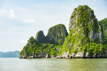 Fototapeta na wymiar Beautiful travel view in the Halong Bay Vietnam landscape ocean and limestone mountain on blue sky background