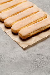 Italian Savoiardi ladyfingers Biscuits on concrete backgound