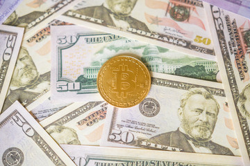 Bitcoin cryptocurrency on us dollars close up. Business concept of crypto currency.